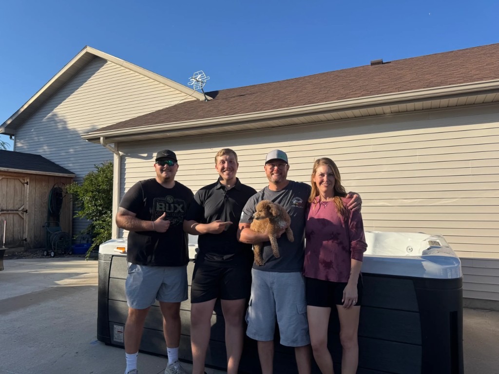 Paradise Spas customers with their new hot tub after delivery